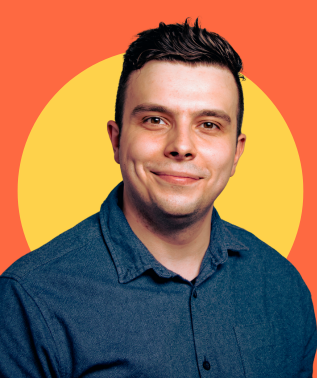 Man with dark hair smiling slightly, wearing a dark blue button-up shirt against a yellow circle on an orange background.