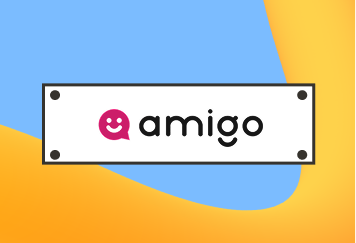 White rectangular sign with the word "amigo" in black text next to a pink speech bubble icon.