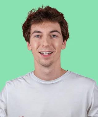 Young, smiling man with brown hair, wearing a white T-shirt, against a light green background.