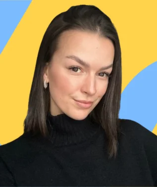 Portrait of a young woman with dark hair, wearing a black turtleneck, against a bright geometric background.